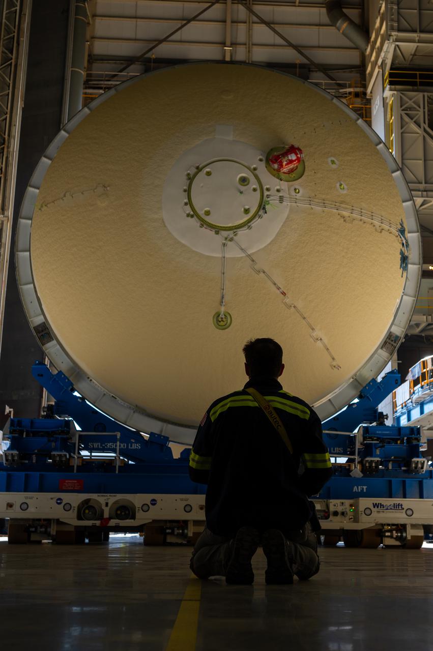 Technicians transported the assembled upper part of the Artemis II core stage to the final assembly area inside the factory at NASA’s Michoud Assembly Facility in New Orleans. On Jan 10, the forward assembly, left was moved next to the Artemis II liquid hydrogen tank, which has been undergoing assembly. Next, Boeing, the lead core stage contractor, will join the forward assembly and the liquid hydrogen tank to complete most of the core stage for the Space Launch System (SLS) rocket that will send the first crew on an Artemis mission. The core stage consists of five major structures that are built, outfitted, and then connected to form the final stage. The forward skirt, liquid oxygen and intertank were connected and tested to form the 66-foot forward assembly. After the forward assembly is joined with the 130-foot liquid hydrogen tank, only the engine section, the fifth piece of the stage, will need to be added to complete the Artemis II core stage. The core stage serves as the backbone of the rocket, supporting the weight of the payload, upper stage, and crew vehicle, as well as the thrust of its four RS-25 engines and two five-segment solid rocket boosters attached to the engine and intertank sections. On Artemis II, the SLS rocket will launch the Orion spacecraft and a crew, sending them into lunar orbit, in preparation for later Artemis missions that will enable the first woman and first person of color to land on the Moon.